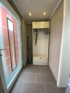 a hallway with a closet with a tiled floor at Ferienwohnung 1 Schweizer in Geisingen