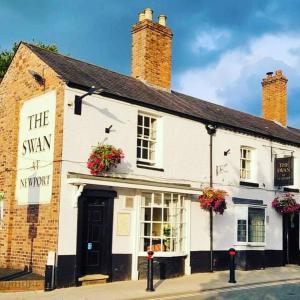 a white building with flowers in the window at The Swan Inn Newport in Newport