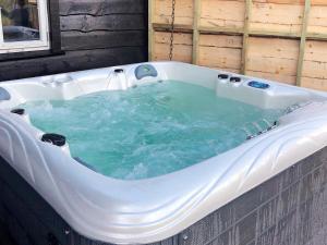 a jacuzzi tub with blue water in it at 10 person holiday home in SERAL in Åseral