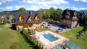 an aerial view of a house with a swimming pool at Apartamenty Liliowe SPA & Wellness in Murzasichle