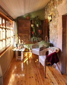 a living room with a table and chairs and a window at Casa Susarón in Puebla de Lillo