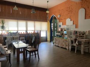 a room with tables and chairs in a store at Sea House in Magong