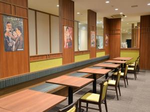 a row of tables and chairs in a cafeteria at Takasago Onsen in Asahikawa