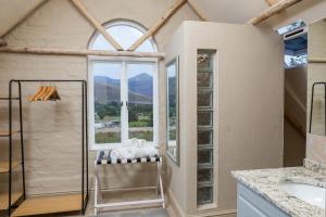 a bathroom with a shower and a window at Heuwelsig Farm Cottages in Franschhoek +49 photos