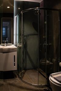 a bathroom with a shower and a sink at Ikaros Art Hotel in Agios Nikolaos