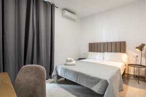 Postel nebo postele na pokoji v ubytování Villamarta Boutique Rooms