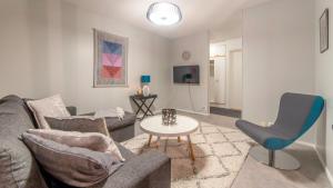 a living room with a couch and a table at Kuukkeli Apartments in Saariselka