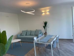 a living room with a couch and a glass table at Villa antonini. in Lerici