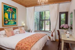 Ένα ή περισσότερα κρεβάτια σε δωμάτιο στο Heuwelsig Cottages