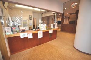 a store with a counter with signs on it at Takasago Onsen in Asahikawa