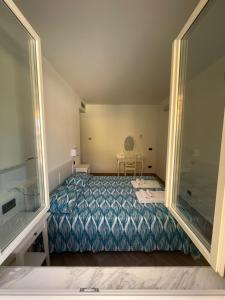 a bedroom with a bed and a chair in it at Villa antonini. in Lerici