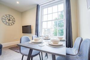 a dining room with a table and chairs and a window at Guest Homes - Shaw Street Dwelling in Worcester