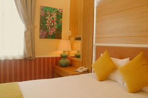 Postel nebo postele na pokoji v ubytování Sao Vang Hotel