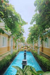 una piscina en medio de un edificio con árboles en Sao Vang Hotel, en Bao Loc
