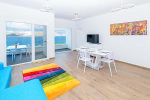 a living room with a colorful rug and a table at Villa The Secret Diamond in Pag