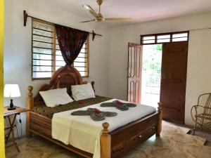 a bedroom with a large bed with a wooden headboard at Magharibi House in Nungwi