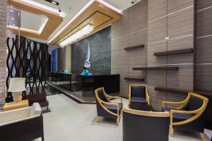 a lobby of a hotel with chairs and a bar at The Marina Phuket Hotel in Patong Beach