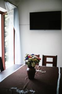 a vase of flowers sitting on top of a table at Willa Zacisze - Apartament dwupoziomowy in Kalwaria Zebrzydowska