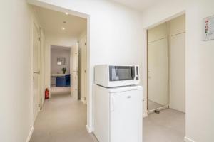 ブルージュにあるModern guest house in centre of Brugesの冷蔵庫の上に電子レンジが備わる客室です。