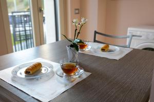 a table with two plates of food and a cup of tea at Casa Dolce Casa - Casa Vacanze in Ariano Irpino
