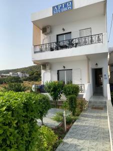 a white building with a balcony and a walkway at Argo in Skala