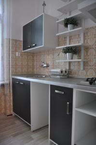 a kitchen with a black and white counter top at Apartament Sopot Andre in Sopot