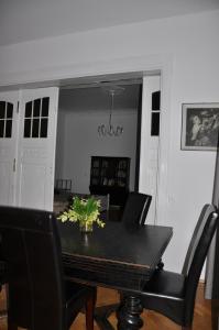 a dining room with a black table and chairs at Apartament Sopot Andre in Sopot