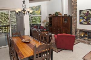 a dining room with a table and a fireplace at All Seasons G4 Condo in Vail
