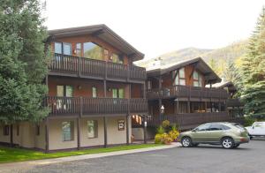 a green car parked in front of a large building at All Seasons G4 Condo in Vail