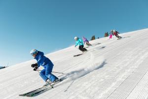 a group of people skiing down a snow covered slope at All Seasons G4 Condo in Vail