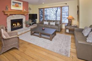 a living room with a couch and a fireplace at Aspenwood Lodge #201 Condo in Edwards