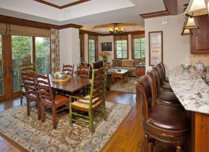 a kitchen and dining room with a table and chairs at Ritz Carlton Residence Vail #112 Condo in Vail