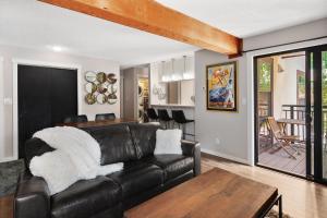 a living room with a leather couch and a table at Breakaway West #212 condo in Vail