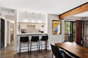 a kitchen and dining room with a table and chairs at Breakaway West #212 condo in Vail