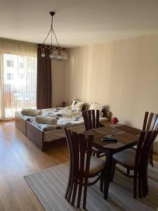 a room with a bed and a table and chairs at Bansko SPA Studio at Predela1 in Bansko