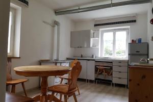 a kitchen with a wooden table and a table and chairs at Relax al lago di Braies in Braies