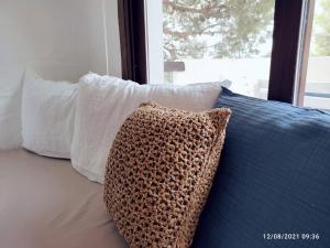 2 cuscini e un cuscino su un divano con finestra di AZUL FORMENTERA a Es Pujols