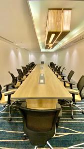 a large conference room with a long table and chairs at Iris Boutique Jazan in Jazan