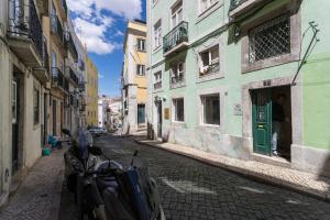 リスボンにあるCharming Apartment Travessa do Alcaideの出入口に立つ男の通り