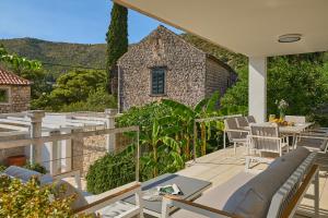 a patio with a couch and a table and chairs at Hedera Estate, Villa Hedera III in Zaton