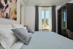 a white bed in a room with a window at Hedera Estate, Villa Hedera III in Zaton +58 photos