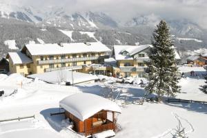 a resort in the snow with a christmas tree at Hotel Moser in Schladming