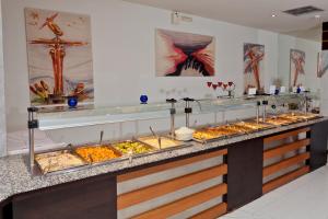 a buffet line with many different types of food at Cathrin Hotel in Faliraki