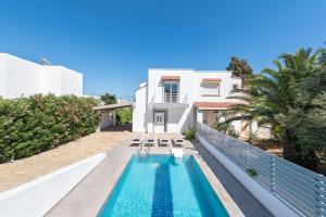 a villa with a swimming pool and a house at Casa Greco in Gennadi