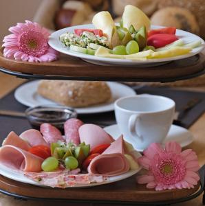 
a table topped with plates of food and cupcakes at Hotel Waren-Alte Warener Zeitung in Waren
