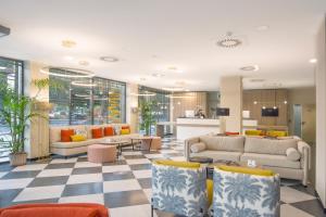 a living room with couches and a checkered floor at Soho Boutique Córdoba in Córdoba