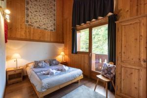 a bedroom with a bed with two dogs laying on it at Chalets Kandahar - Mountain Collection in La Rosière