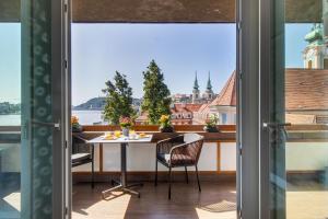 a view from a balcony with a table and chairs at Danube Pearl Boutique Apartment in Budapest