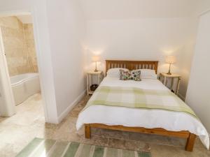 a bedroom with a bed and a bath tub at The Apple Barn in Daventry