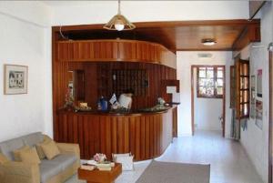 a living room with a couch and a kitchen at Sunlight Hotel in Agia Galini